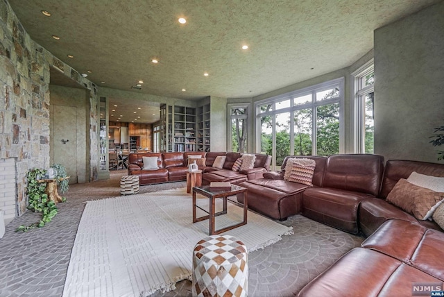 living room featuring carpet flooring and a textured ceiling