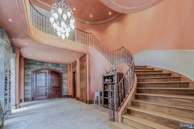 entryway with a towering ceiling and ornamental molding