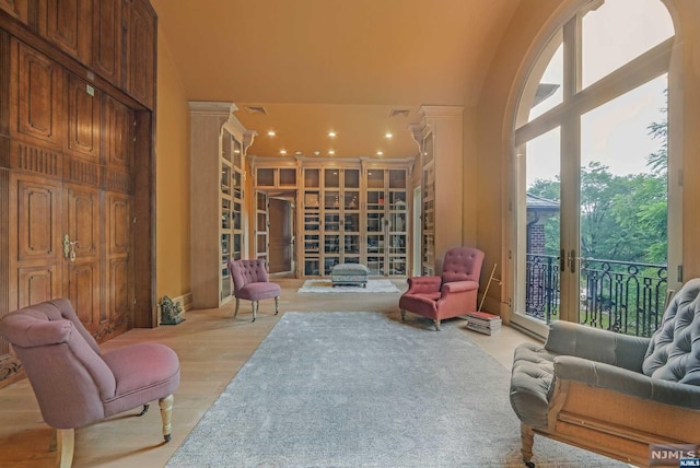 living area with light hardwood / wood-style flooring and lofted ceiling