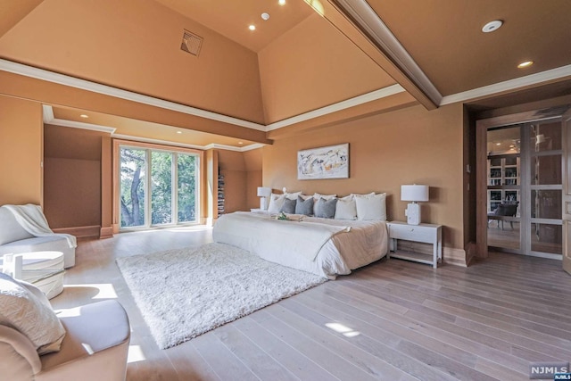 bedroom with beamed ceiling, wood-type flooring, ornamental molding, and high vaulted ceiling