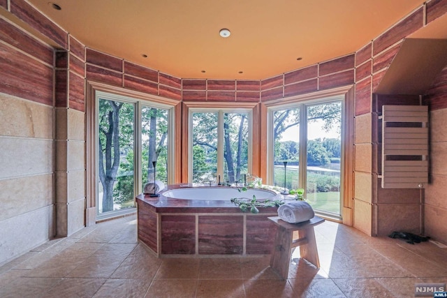 bathroom featuring tile walls and a bathing tub