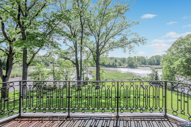 balcony featuring a water view