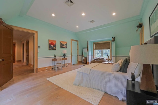 bedroom featuring light wood-type flooring and ornamental molding