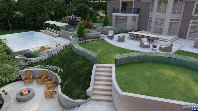 view of yard with a patio area, a balcony, and a fire pit