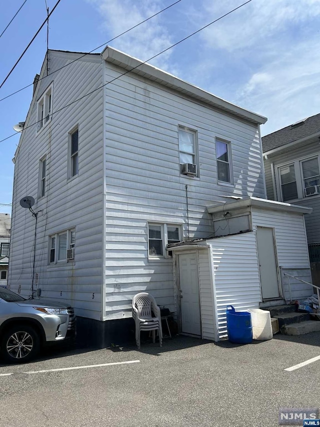 back of property featuring cooling unit