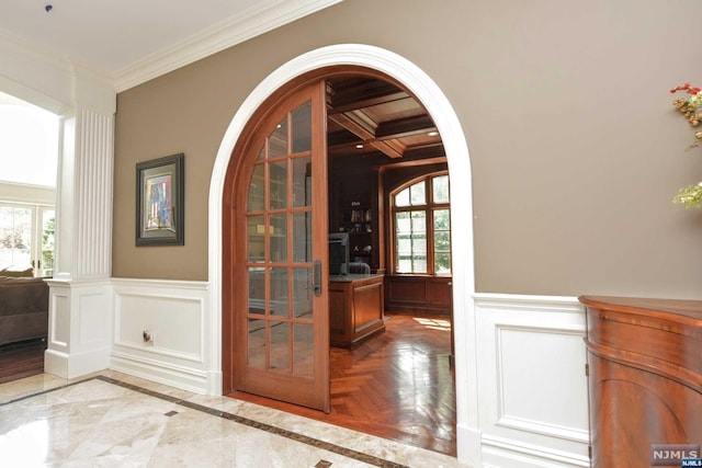 interior details with parquet floors, coffered ceiling, french doors, crown molding, and beam ceiling