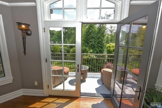 entryway featuring wood-type flooring and crown molding