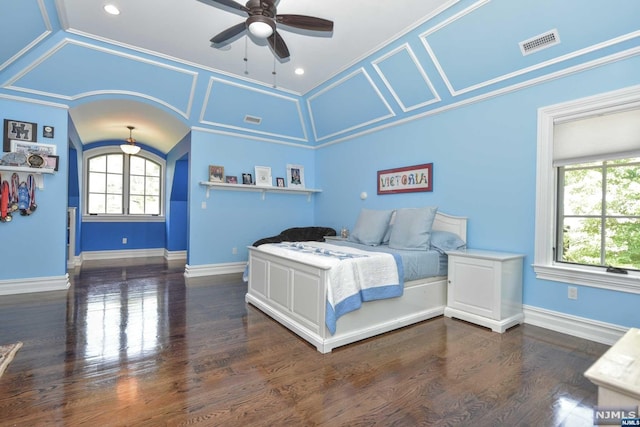 bedroom with crown molding, ceiling fan, and dark wood-type flooring