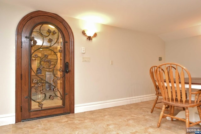 dining space featuring vaulted ceiling