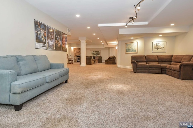 living room featuring carpet, rail lighting, and ornate columns