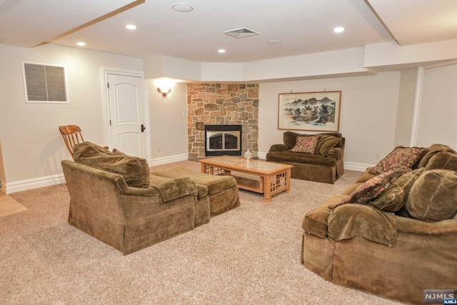 living room featuring a fireplace and light colored carpet