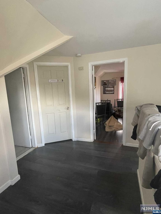 corridor featuring dark hardwood / wood-style floors