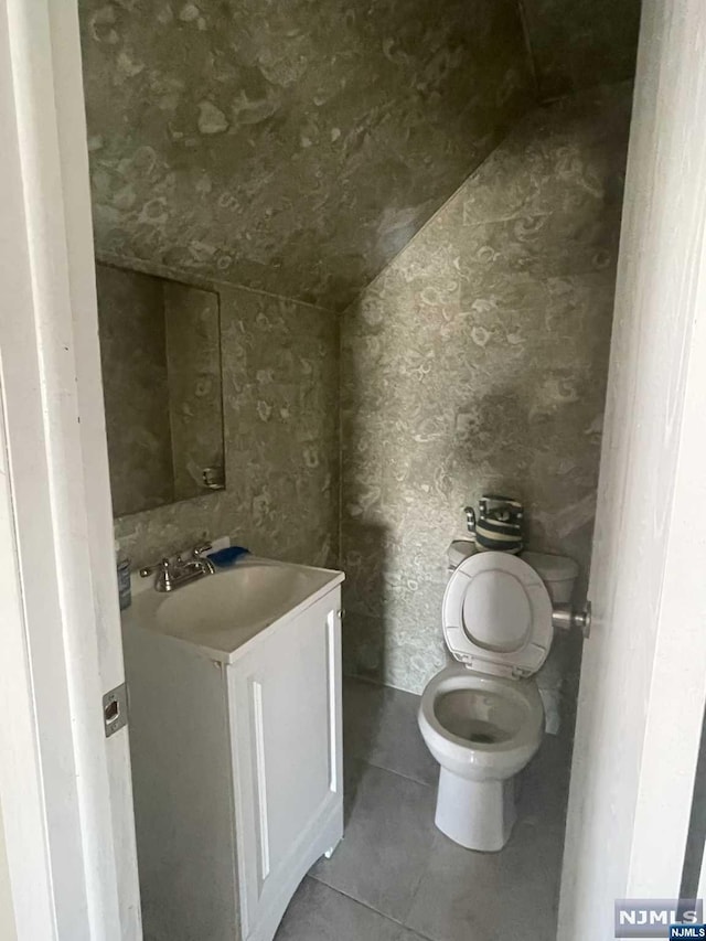 bathroom with tile patterned floors, vanity, and toilet