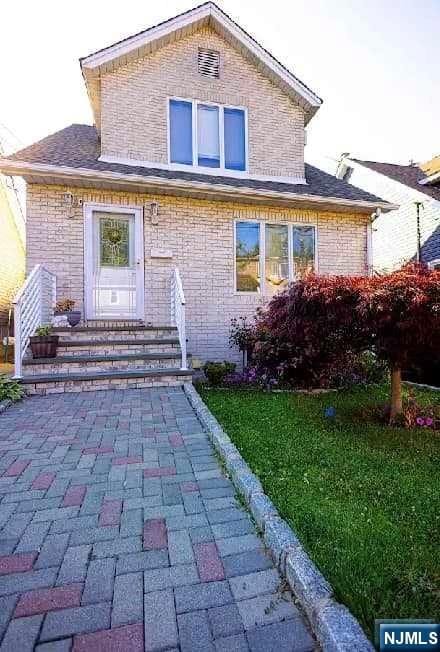 rear view of house featuring a yard