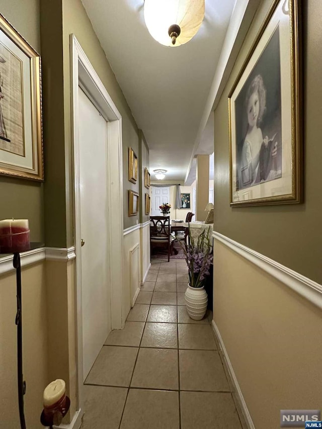 corridor featuring light tile patterned floors