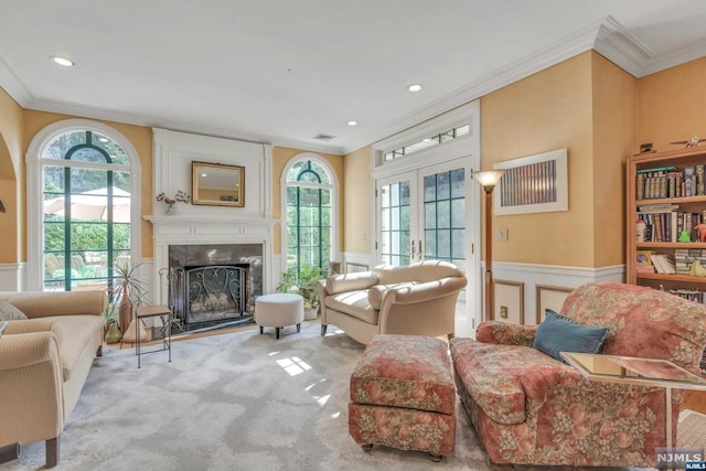 living room featuring ornamental molding, light carpet, a high end fireplace, and french doors