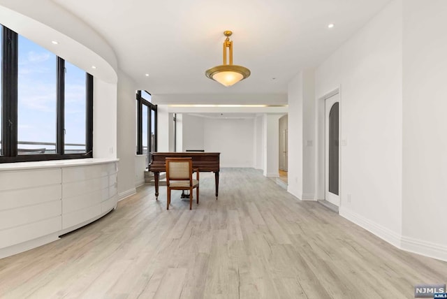 corridor with light hardwood / wood-style flooring