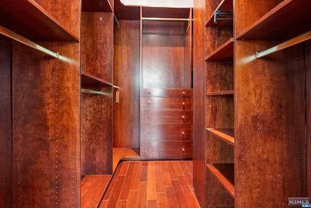 spacious closet featuring hardwood / wood-style flooring