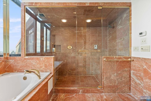 bathroom with separate shower and tub