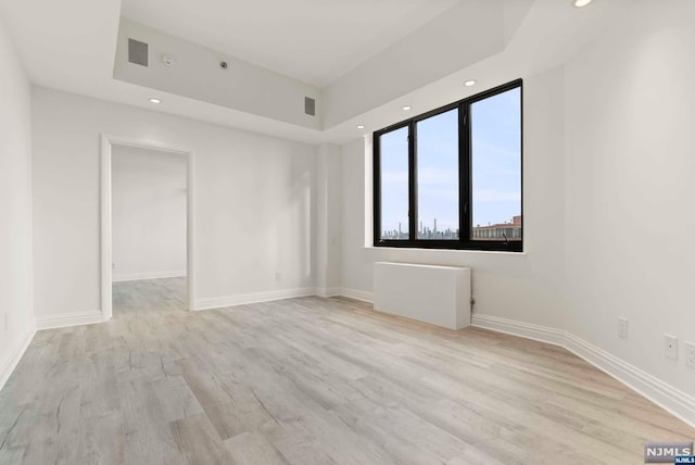 empty room with light hardwood / wood-style flooring