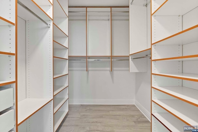 walk in closet featuring light hardwood / wood-style flooring