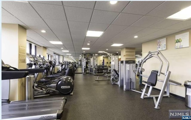 exercise room featuring a paneled ceiling