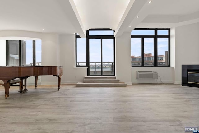 interior space with light hardwood / wood-style flooring and a wall mounted AC