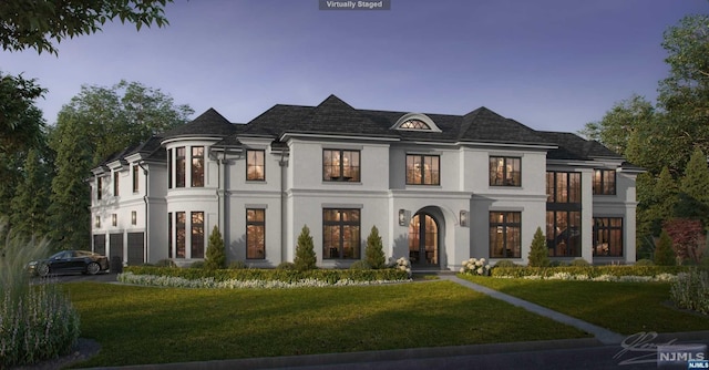 view of front facade with a lawn and a garage