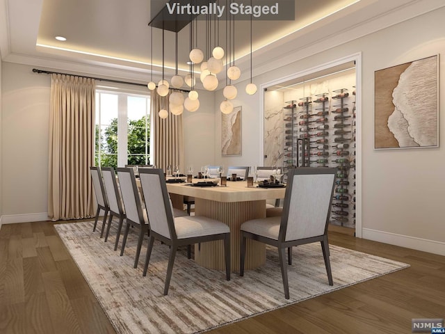 dining area featuring dark hardwood / wood-style floors and a tray ceiling