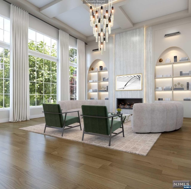 interior space featuring built in shelves, hardwood / wood-style floors, and a fireplace