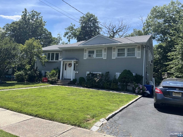 bi-level home with a front lawn