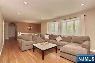 living room featuring hardwood / wood-style flooring and a chandelier