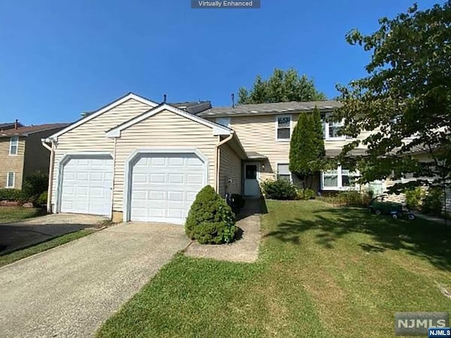 view of front of home featuring a front lawn and a garage