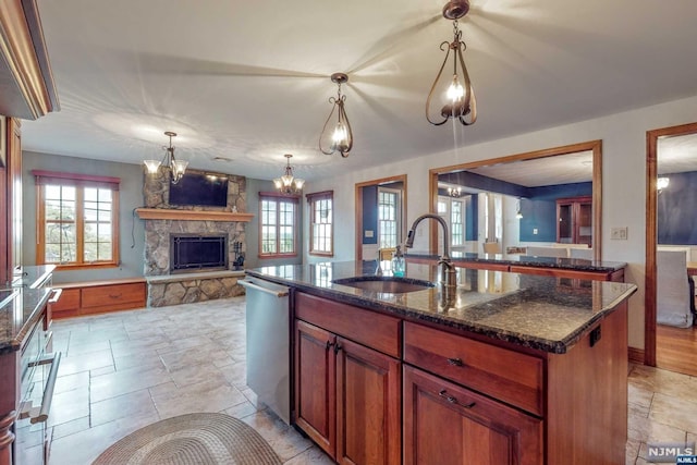 kitchen with dishwasher, a center island with sink, plenty of natural light, and sink