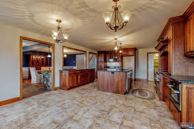 kitchen featuring decorative light fixtures, a kitchen island, stainless steel appliances, and a chandelier