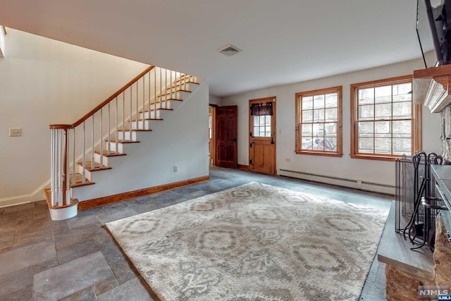 unfurnished living room featuring a baseboard heating unit