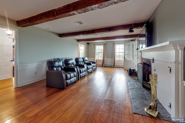 living room with hardwood / wood-style floors and beamed ceiling