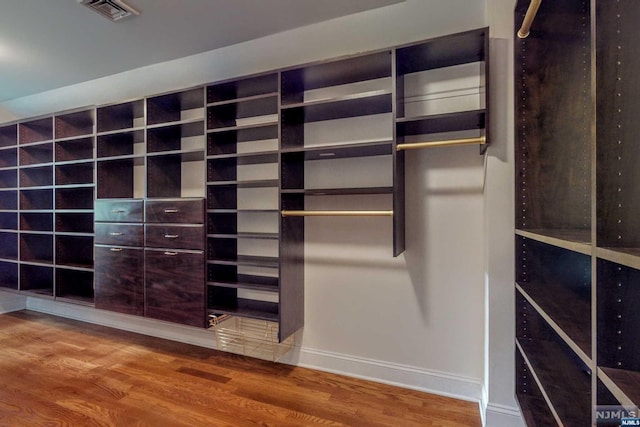 spacious closet with hardwood / wood-style floors