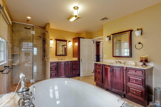 bathroom with vanity and a shower with shower door