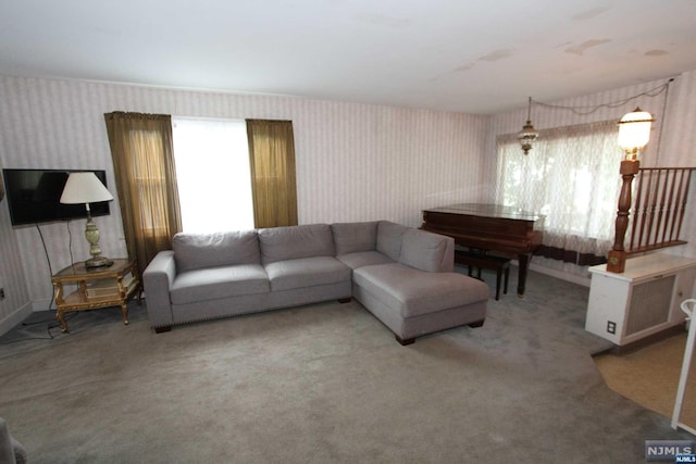 living room featuring carpet floors and a wealth of natural light