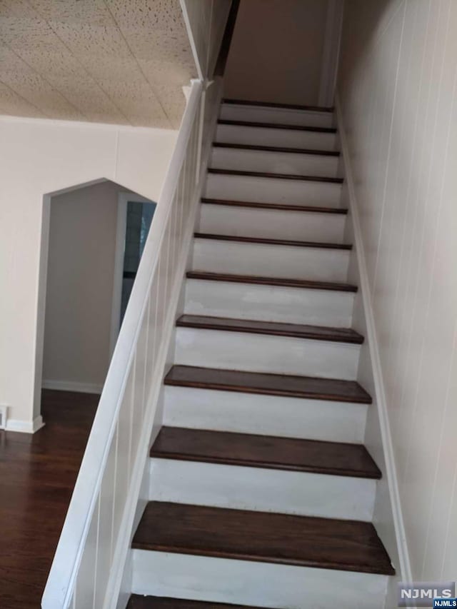 stairway featuring hardwood / wood-style flooring