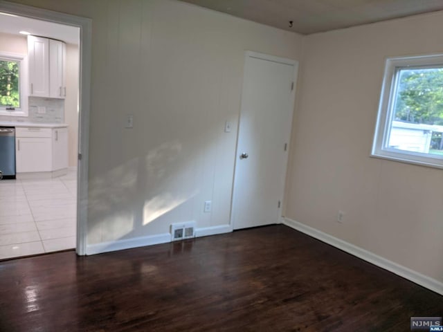 unfurnished room with wood-type flooring