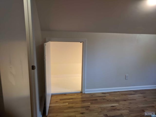 empty room with dark hardwood / wood-style flooring