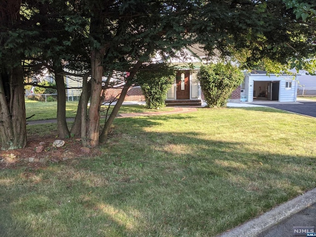 obstructed view of property featuring a front lawn