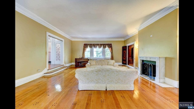 unfurnished living room with hardwood / wood-style flooring, crown molding, and a high end fireplace