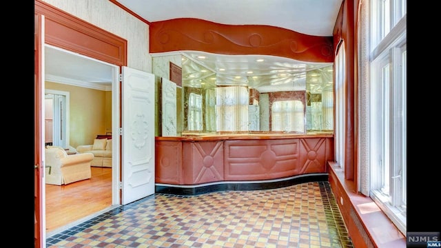 bathroom with hardwood / wood-style floors and crown molding