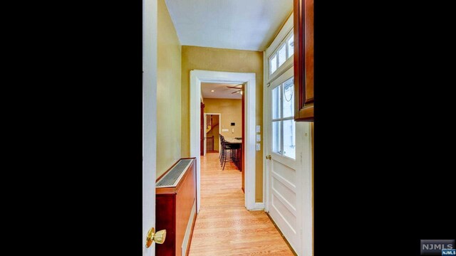 hallway with light hardwood / wood-style flooring