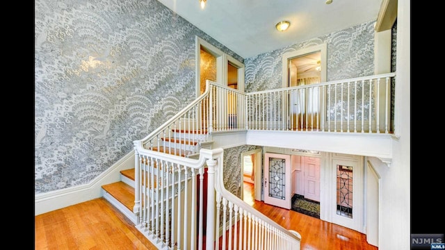 stairs featuring hardwood / wood-style floors