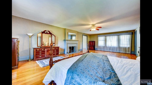 bedroom with ceiling fan and wood-type flooring