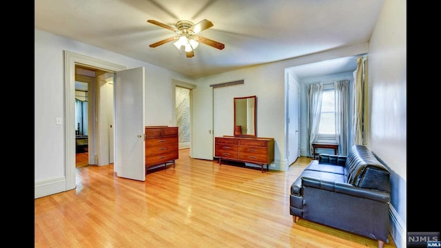 living area with light hardwood / wood-style flooring and ceiling fan